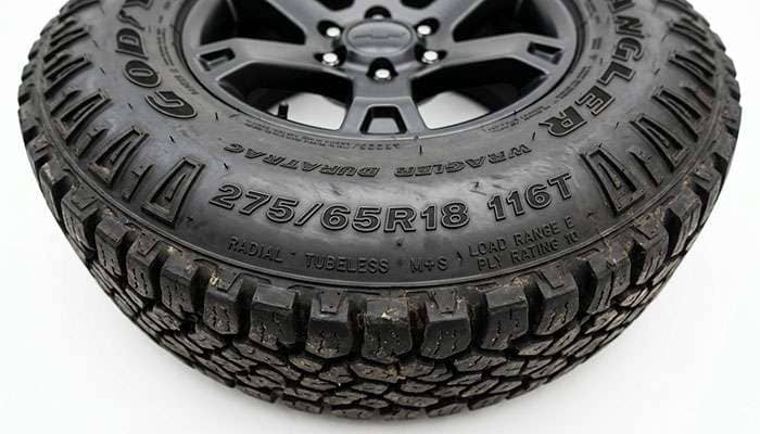 Close-up of a pickup truck tire sidewall showing the tire size and load index