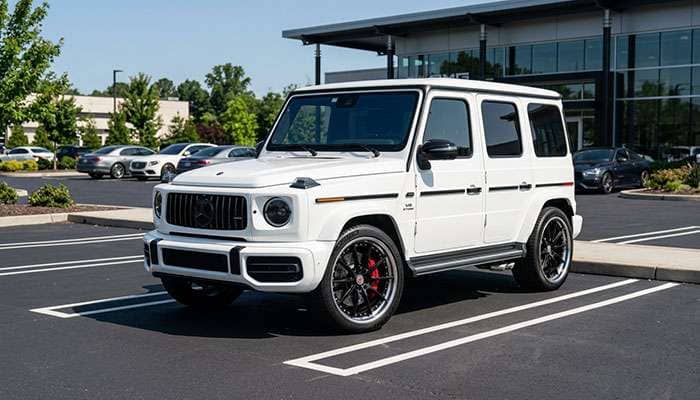 White luxury car with custom wheels in a parking lot under the text What Fits and a large yellow arrow