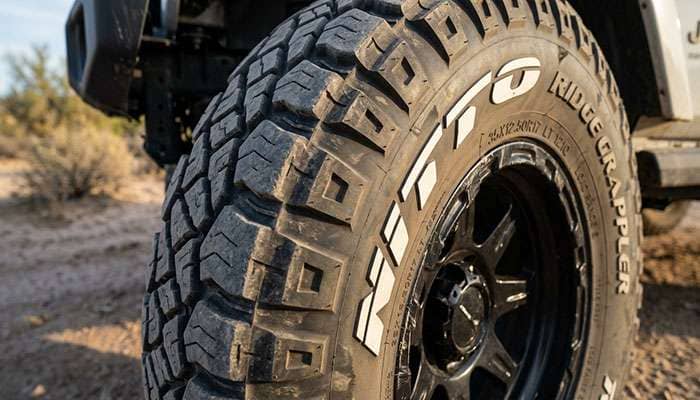 Close-up of Nitto Ridge Grappler aggressive staggered sidewall lugs and raised NITTO lettering