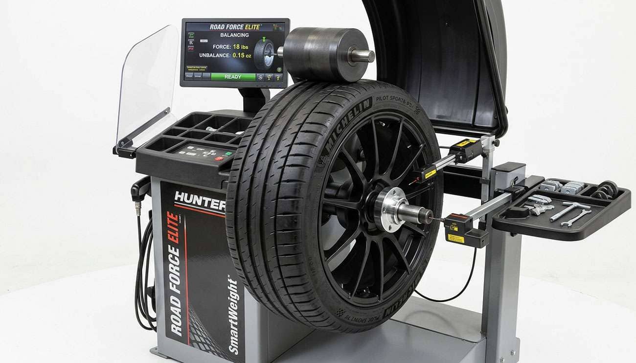 Tire and wheel assembly mounted on a road force balancing machine with the load roller pressed against the tread