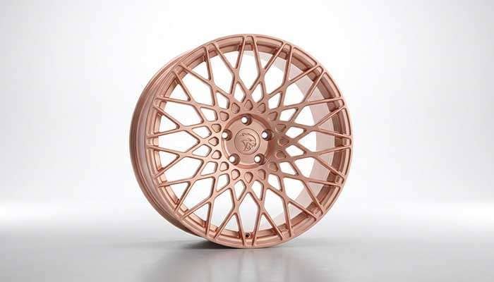 Close-up of a custom rose gold forged RVRN wheel with intricate multi-spoke design for Dodge Charger Hellcat