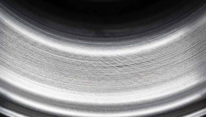 Close-up of a flow formed wheel barrel showing the compressed grain structure from the rotary forming process