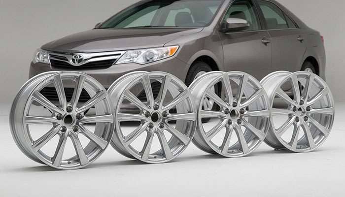 Set of four 17x7 inch silver wheels compatible with 2012-2014 Toyota Camry, shown with a gray Camry sedan