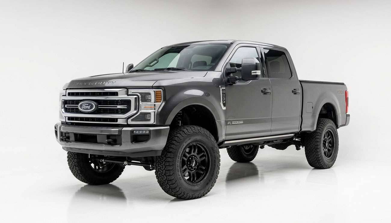 Heavy-duty crew cab pickup truck with a leveled front end and 35-inch all-terrain tires on eight-lug wheels