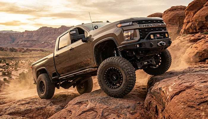 Silverado ZR2 on LT275/70R18 33-inch mud-terrain tires crawling over desert rock