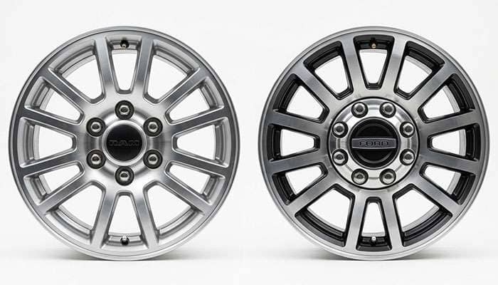 Six-lug half-ton truck wheel next to an eight-lug heavy-duty truck wheel