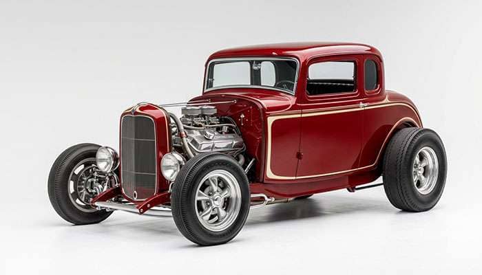 Vintage hot rod with staggered slot mag wheels and period-correct tires