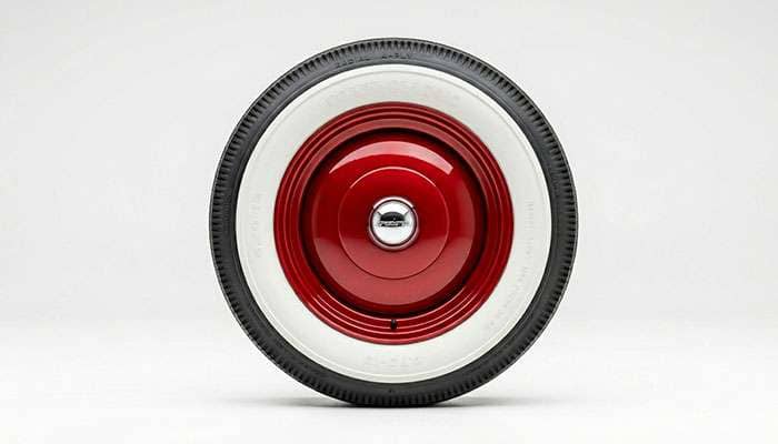 Smoothie wheel mounted with a wide whitewall tire showing classic stance, studio photo