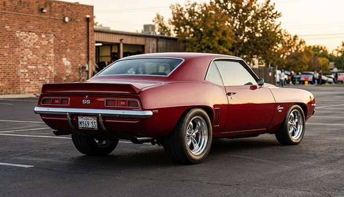 Rear three-quarter view of a classic muscle car on a staggered setup with wider rear tires