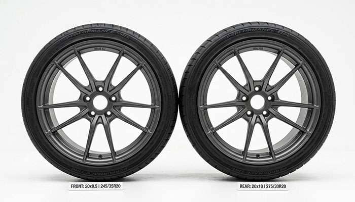 Narrower front tire and wider rear tire mounted on staggered 20-inch wheels