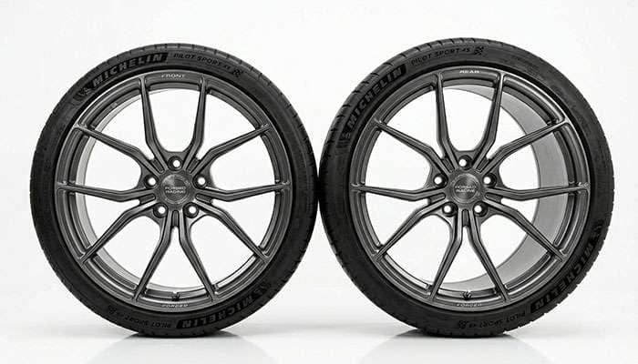 Front 20x8.5 wheel next to a wider 20x10 rear wheel showing the staggered width difference