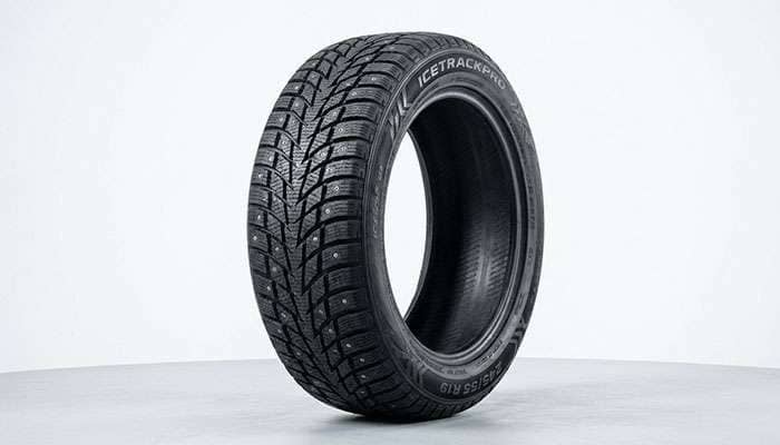 Studded winter tire showing metal studs embedded in tread pattern for ice traction