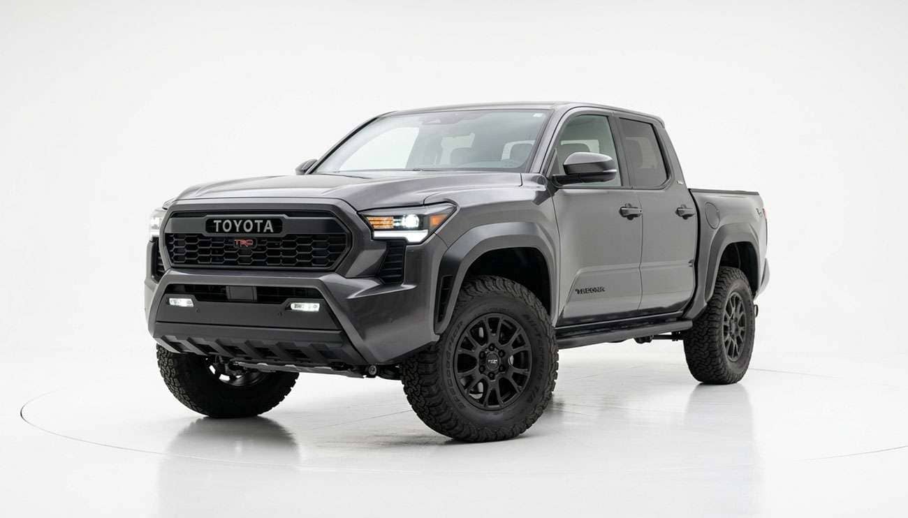 Midsize pickup truck on stock suspension fitted with 33-inch all-terrain tires, front three-quarter view