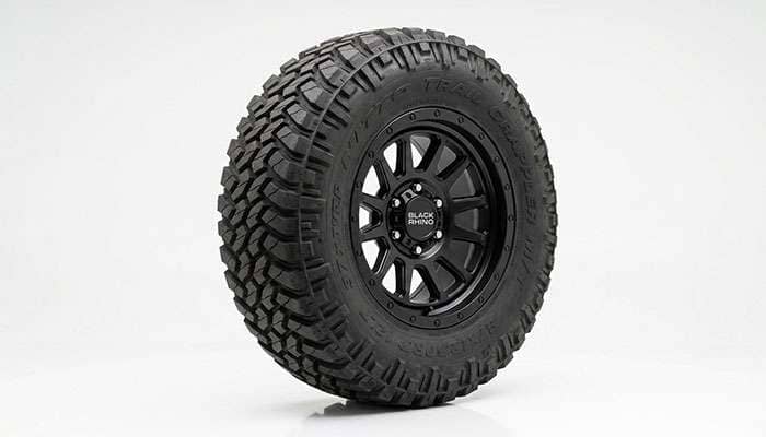 A tall upsized off-road tire showing its large overall diameter
