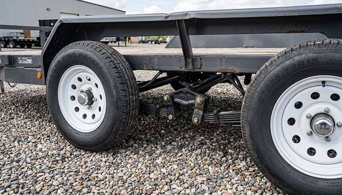 Tandem-axle utility trailer on ST225/75R15 radial trailer tires, showing both tires on one side of the axle set