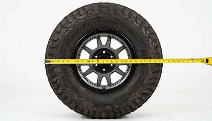 Tape measure measuring the diameter of a large off-road tire