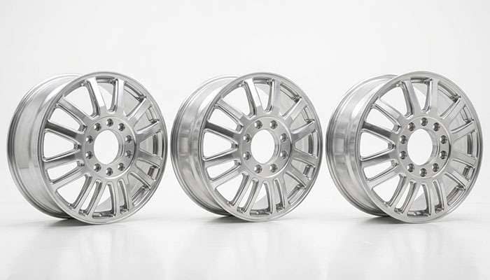 Three different dually wheels lined up showing the same wheel design in different bolt pattern fitments
