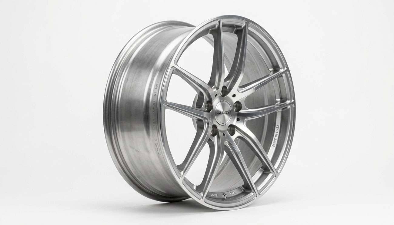 A bare alloy wheel rim shown without a tire, highlighting the bead seat and rim profile, on a clean white studio backdrop