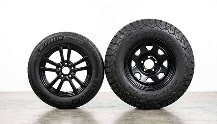 Two tires of different overall diameters positioned side by side for comparison