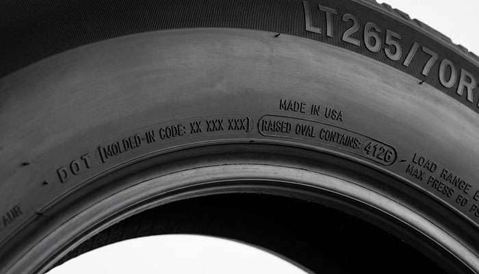 Close-up of the four-digit DOT date code molded into a modern tire sidewall