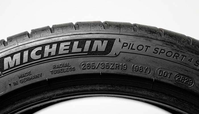 Close-up of a tire sidewall DOT code and plant code used to verify where the tire was manufactured