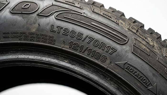 Tire sidewall service description showing load index and speed rating markings