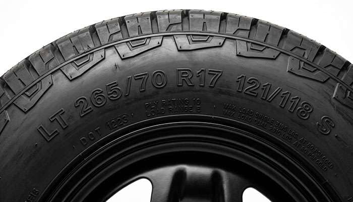 Close-up of a truck tire sidewall showing the size and load index markings