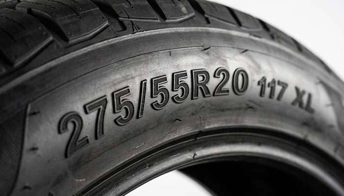 Close-up of a truck tire sidewall showing the 275/55R20 size marking with load index and XL designation