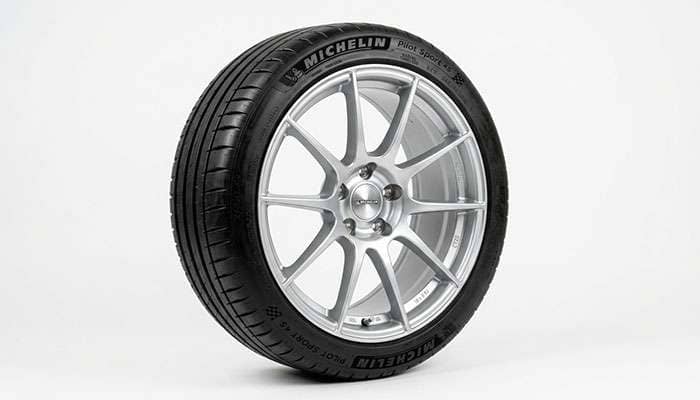 Tire mounted on an alloy wheel illustrating rim width fitment on a white studio backdrop