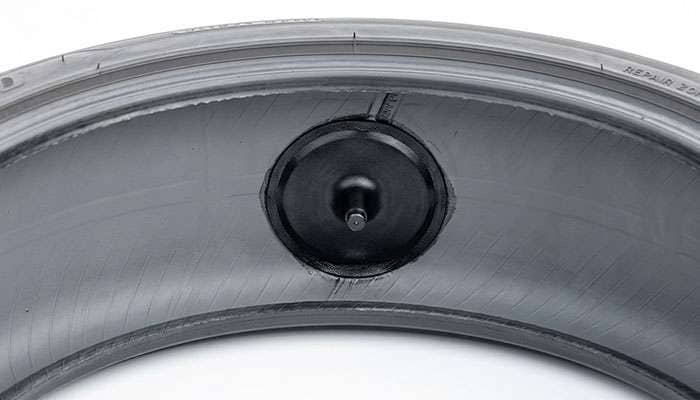 Combination patch-plug repair unit installed on the inner liner of a tire seen from inside the casing