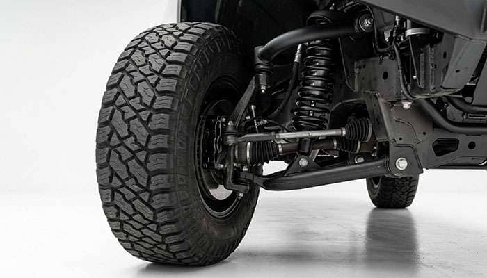 Lifted pickup front tire turned to full lock with its inner shoulder close to the upper control arm
