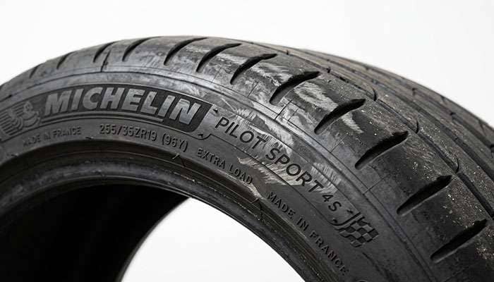 Tire sidewall showing light scuff marks from fender liner contact