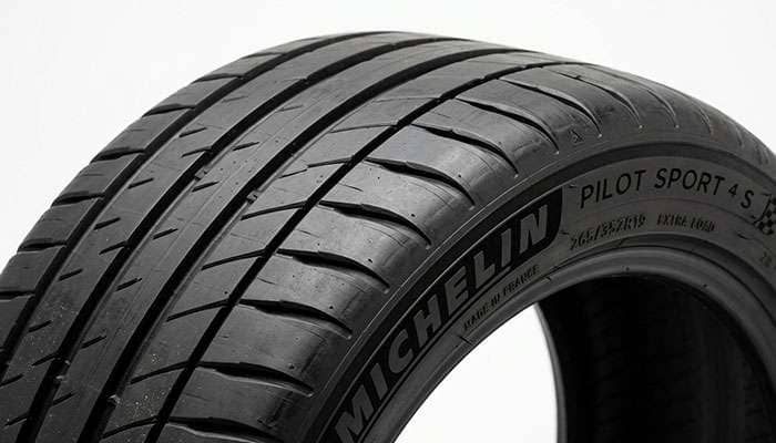 Close-up of a tire shoulder where the tread edge curves down into the sidewall