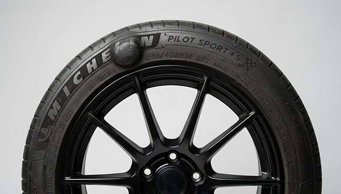 Close-up of a tire sidewall showing a bubble or bulge from impact damage