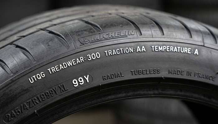 tire sidewall showing UTQG treadwear traction temperature ratings alongside load index and speed rating markings