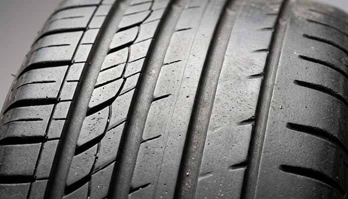 Detail of tire tread showing differential wear pattern from skipped rotations