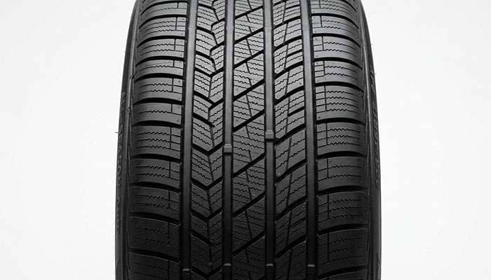 Close-up of a tire tread pattern showing water-evacuation grooves and siping