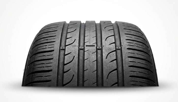 Close-up of a tire tread wear indicator showing the importance of maintaining safe tire tread depth.