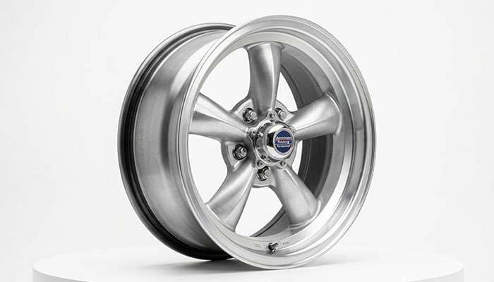 Classic 15 inch American Racing Torq Thrust style aluminum wheel three quarter view