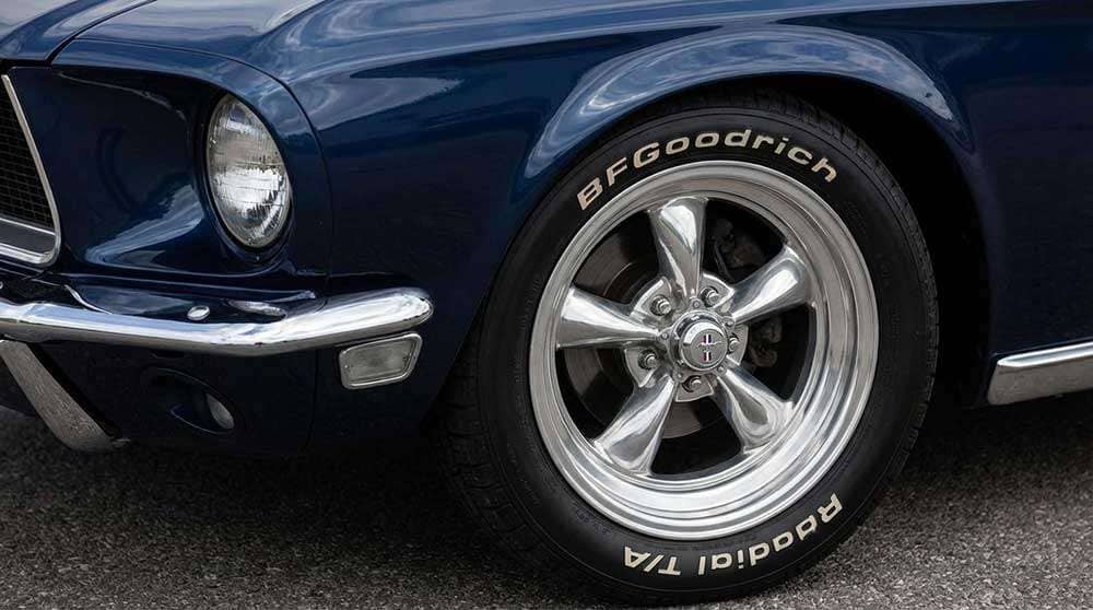 Close-up of American Racing Torque Thrust II wheels mounted on a Ford Mustang