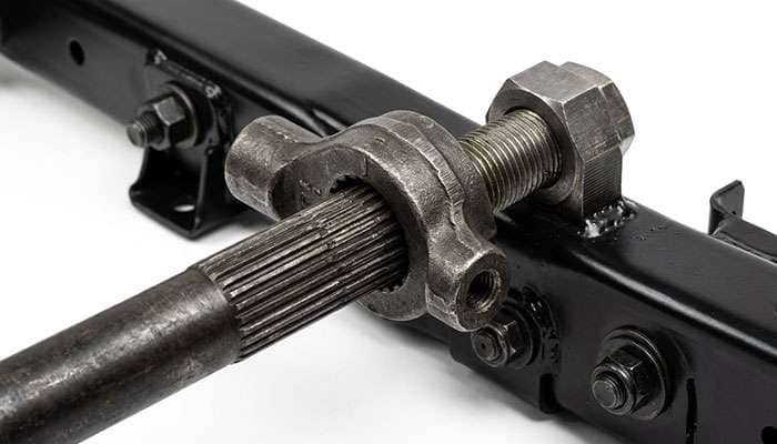 Torsion bar key and adjuster bolt on a heavy-duty truck front suspension crossmember