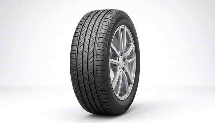 Touring tire on sedan wheel showing comfort-focused tread design