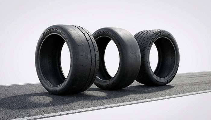 Three high-performance track tires displayed on a racetrack background with 'Best Track Tires' text above