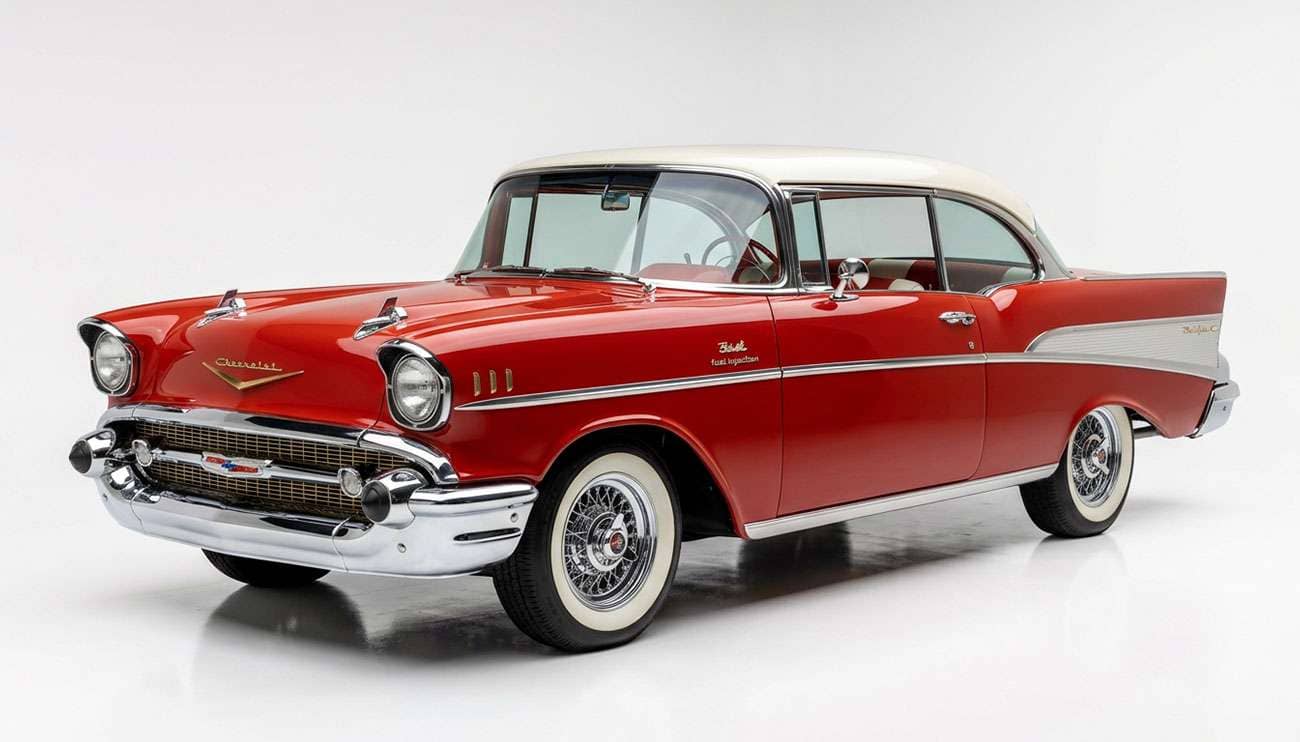 Classic 1950s two-door hardtop with wide whitewall tires and chrome wheels