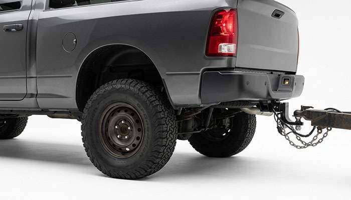 Rear all-terrain tires of a pickup compressed under trailer tongue weight at the hitch