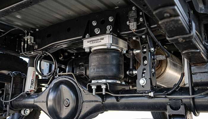Rear air suspension leveling spacer and ride height sensor bracket installed on a 2022 Toyota Tundra