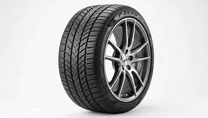 Ultra-high-performance all-season tire with asymmetric tread and wide shoulder blocks on a clean white seamless studio backdrop