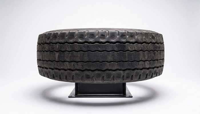 Close-up of tire showing uneven wear pattern and cupping caused by imbalanced wheels with missing wheel weights