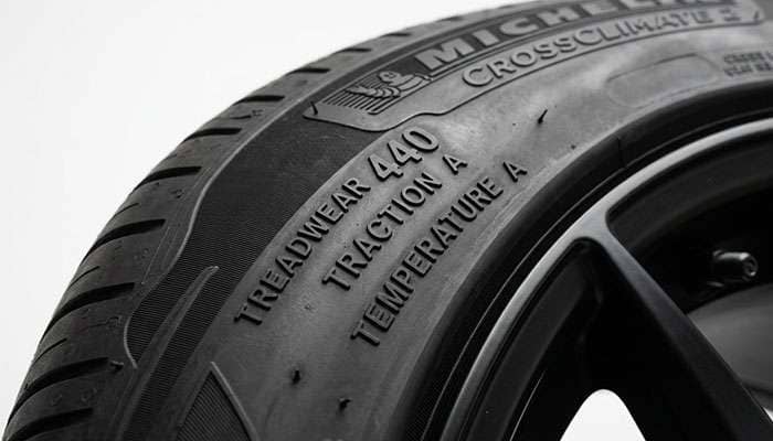 Tire sidewall close-up showing UTQG treadwear rating