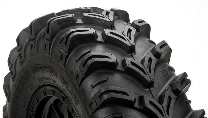 Close-up of an aggressive UTV mud tire tread pattern with deep lugs